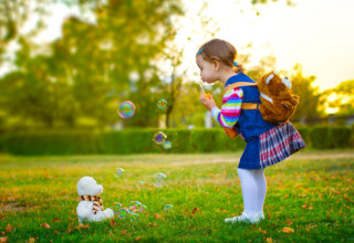 girl playing bubbles